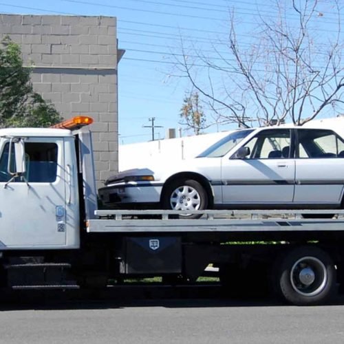aubrey-towing-1 a tow truck with a car on the back