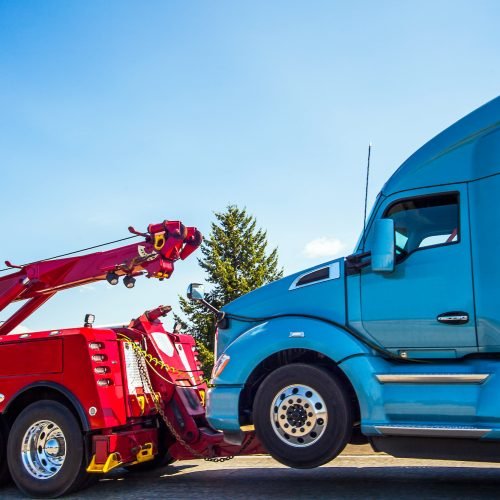 aubrey-towing a blue truck with a crane lifting a red truck